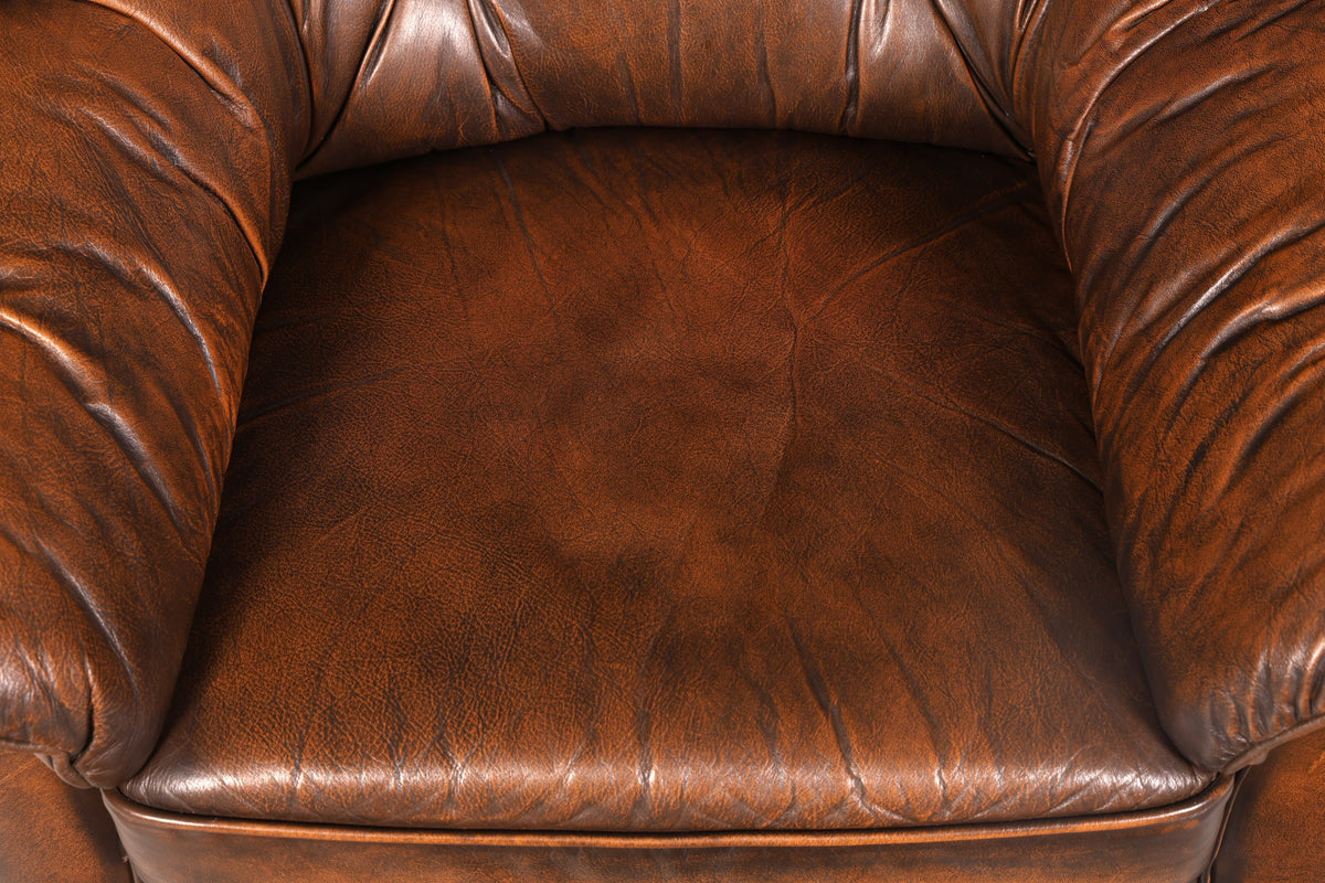 Beautiful brown genuine leather Chesterfield armchair with footstool, English vintage style